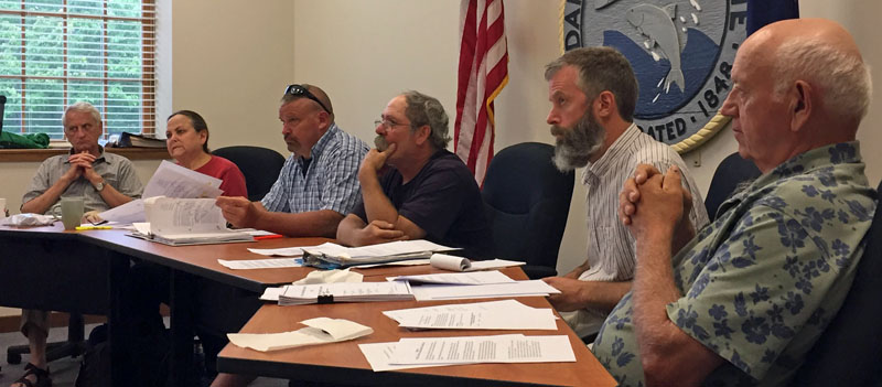 From left: Damariscotta Town Planner Tony Dater and Damariscotta Planning Board members Shari Sage, Neil Genthner, Jonathan Eaton, Adam Maltese, and Wilder Hunt listen to a presentation from representatives of the Dollar General project. (Maia Zewert photo)