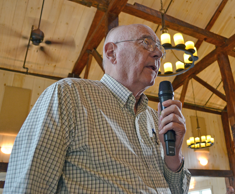 Bristol resident and former LincolnHealth board member Norman Hochgraf asks a question during a public meeting about the MaineHealth unification proposal Wednesday, July 12. (Maia Zewert photo)