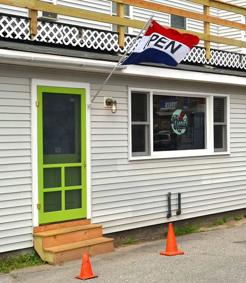 The entrance to Sea Smoke Shop at the side of 95 Main St. in downtown Damariscotta, next to the Colby & Gale Inc. service station. (Maia Zewert photo)