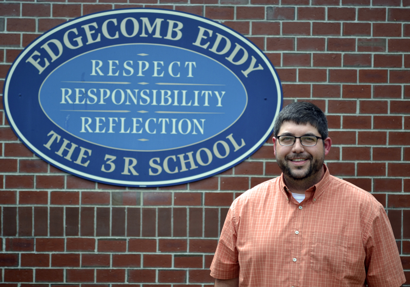 Edgecomb Eddy School Principal Ira Michaud stands in front of the school's sign on Tuesday, July 18, his second day on the job. (Abigail Adams photo)