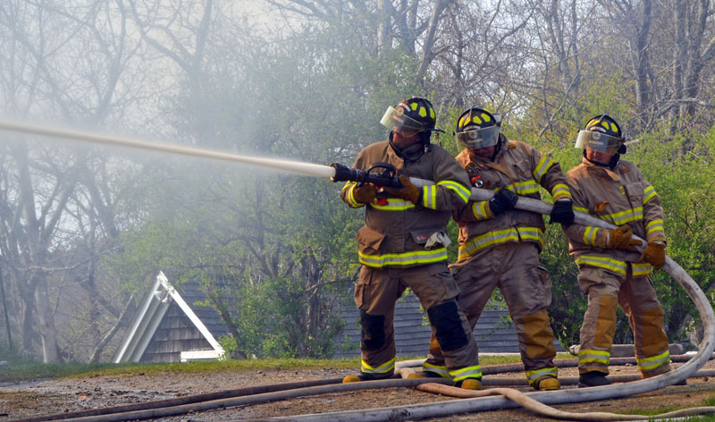 Alna firefighters work on the scene of a house fire at 38 South Dyer Neck Road in Newcastle in May 2016. The Lincoln County Fire Chiefs Association is developing a firefighter strike team to assist with major events. (Maia Zewert photo, LCN file)