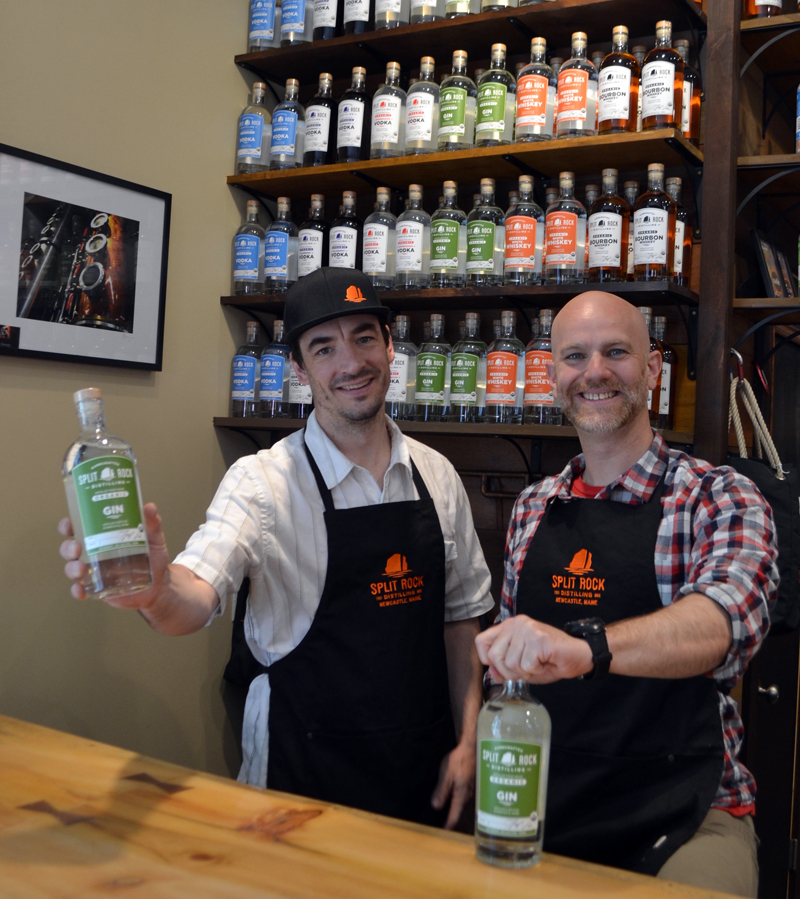 Split Rock Distilling founders Topher Mallory (left) and Matt Page hold the first two bottles of the distillery's gin. The spirit made its official debut Saturday, July 1, on the one-year anniversary of the business's opening. (Maia Zewert photo)