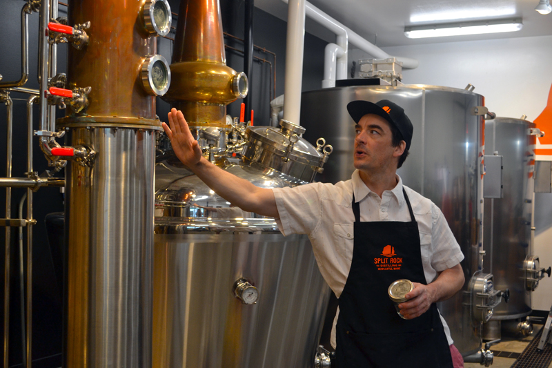 Split Rock Distilling co-founder Topher Mallory leads a tour during the distillerys one-year anniversary celebration Saturday, July 1. (Maia Zewert photo)