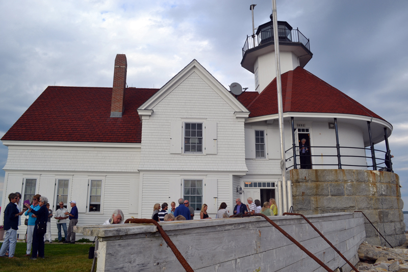 Guests at a fundraiser at Cuckolds Lighthouse on Wednesday, July 10 enjoy a rare glimpse of the results of a decade-long reconstruction and preservation effort. (Abigail Adams photo)