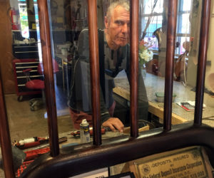 Artist Philippe Guillerm works in his workshop at Philippe Guillerm Gallery in Waldoboro, behind the teller window of the former bank, during ArtWalk Waldoboro, Saturday, July 8. (Christine LaPado-Breglia photo)