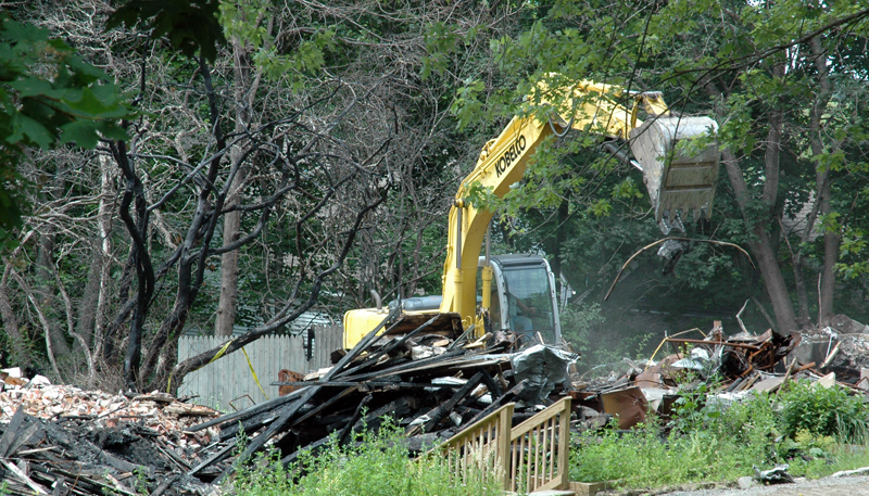 An excavator clears debris at the Reed Mansion site on Glidden Street in Waldoboro the afternoon of Monday, July 10. (Alexander Violo photo)