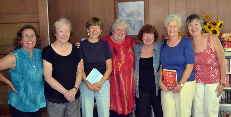 From left: Whitefield Public Library volunteers Cheryl Joslyn, Ann Weiss, Pat Parks, Debbie Rogers, Sue McKeen, Martha Tait, and Margaret Fergusson celebrate the library's opening Wednesday, July 12. (Abigail Adams photo)