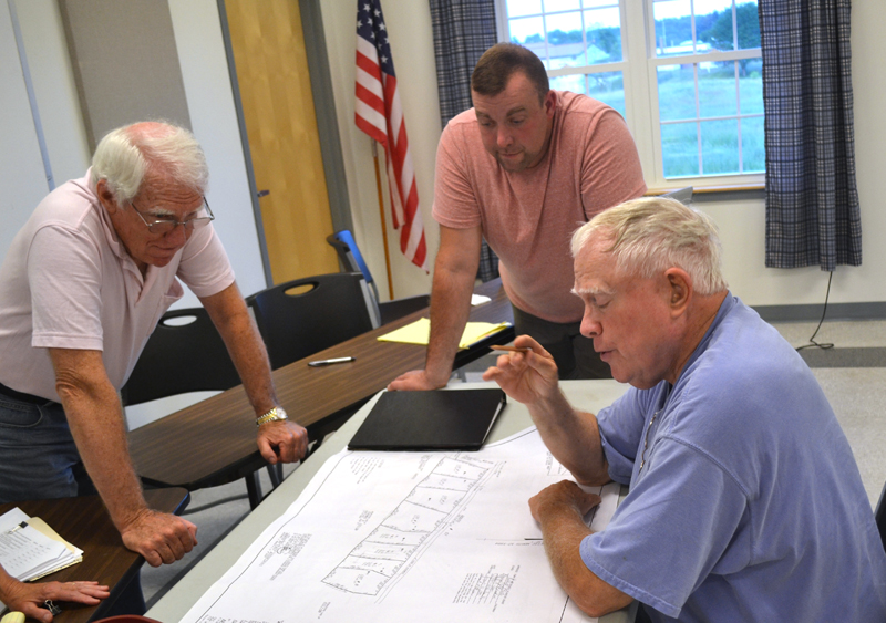 From left: Whitefield Planning Board members Steve Sheehy and Jake Mathews look on as Steve Smith discusses his plans for his Route 17 property during the board's Wednesday, July 19 meeting. (Abigail Adams photo)