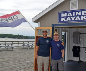 Maine Kayak owner Alvah Maloney and employee Hauns Bassett stand in front of the rental office on the Creamery Pier in Wiscasset on Friday, July 7. (Abigail Adams photo)