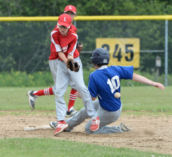 Cooper Waltz attempts to stop a wild throw for the LIons as Aiden Starr steals second for Union Farm Equipment. (Paula Roberts photo)