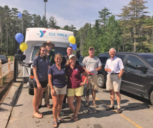 Volunteers help fill the YMCA bus on July 22 at Hannaford Supermarket in Damariscotta to stock the shelves of the Rotary Summer Food for Kids shed.