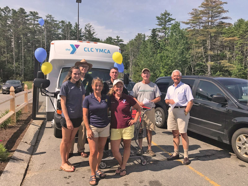 Volunteers help fill the YMCA bus on July 22 at Hannaford Supermarket in Damariscotta to stock the shelves of the Rotary Summer Food for Kids shed.