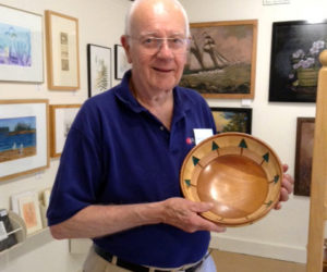 Tom Raymond with a hand-turned bowl.