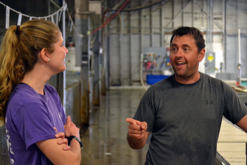 Abby Shaughnessy discusses her research with Curt Brown, UMaine alumnus and a marine biologist at Ready Seafood Co., Portland. (Aliya Uteuova photo)