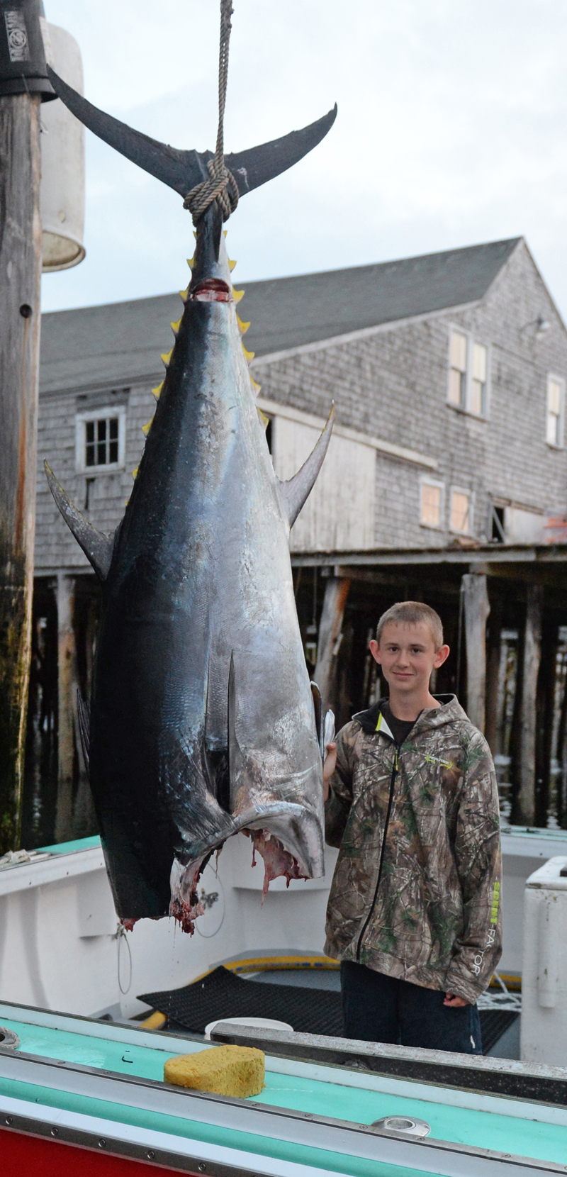 Myles Wotton with the tuna he caught Monday aboard his father's fishing boat, the Red Lady. The fish dressed out at 381 pounds. (Paula Roberts photo)