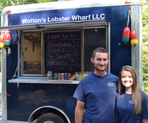 Merritt Wotton and Shannon Barter stand in front of the Wotton's Lobster Wharf LLC mobile kitchen. (Maia Zewert photo)