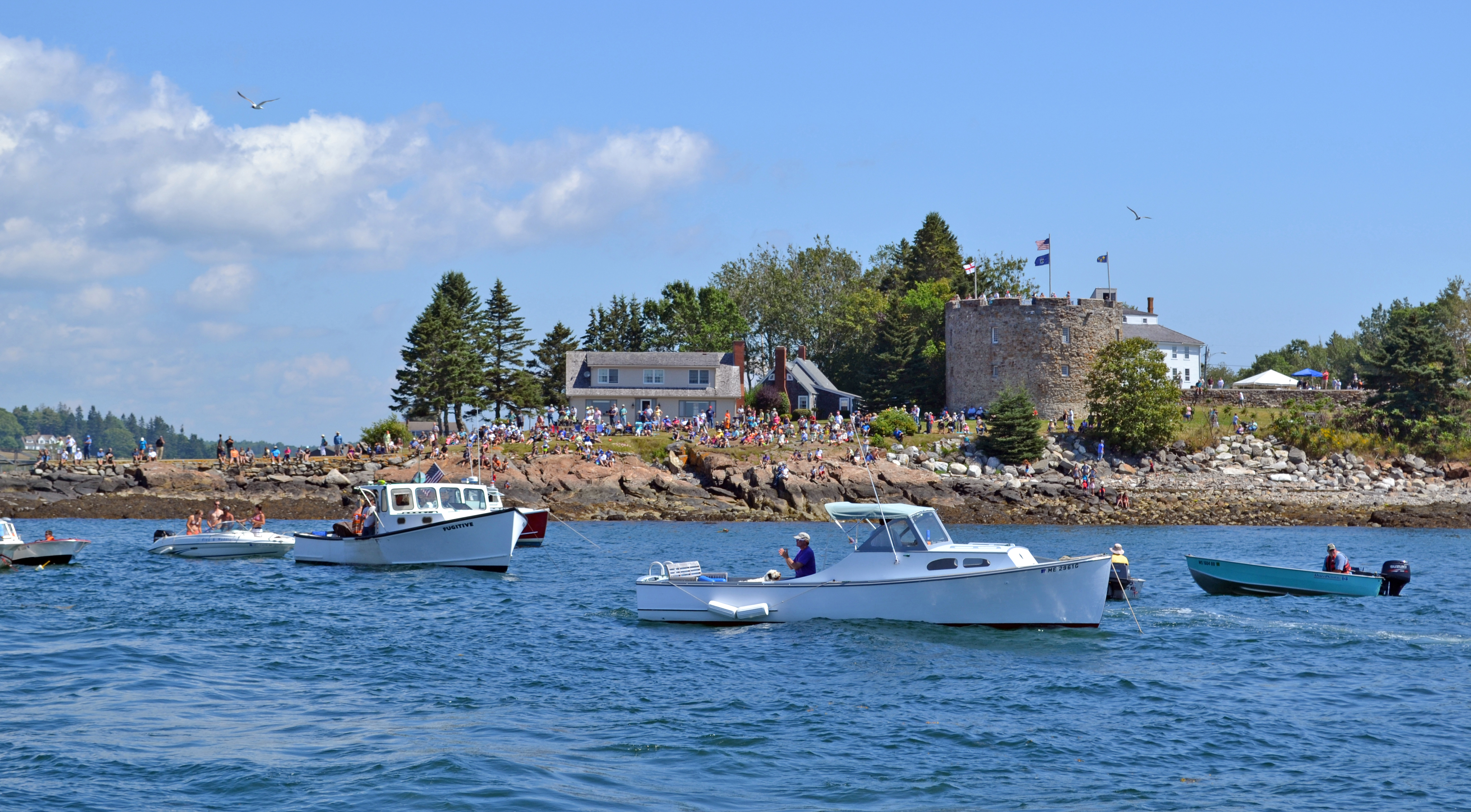 A crowd gathers at Fort William Henry and the neighboring Dodge property to watch the 31st annual Merritt Brackett Lobster Boat Races in Bristol on Sunday, Aug. 13. (Abigail Adams photo)