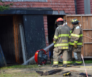 Damariscotta firefighters douse a hot spot in a barn at 23 Biscay Road in Damariscotta the morning of Thursday, Aug. 17. (Maia Zewert photo)