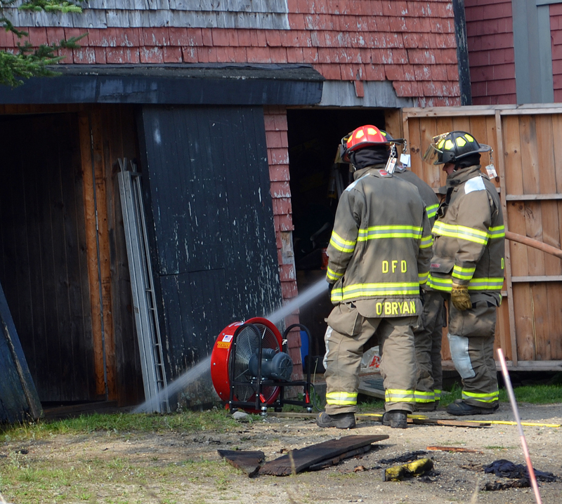 Damariscotta firefighters douse a hot spot in a barn at 23 Biscay Road in Damariscotta the morning of Thursday, Aug. 17. (Maia Zewert photo)