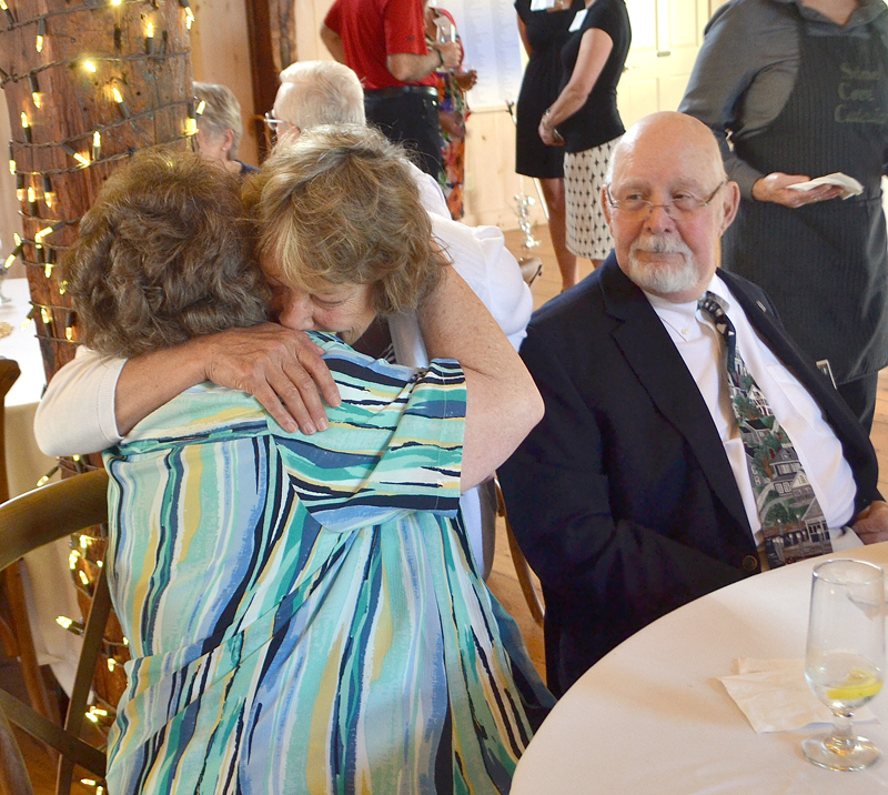 LincolnHealth Director of Volunteers Connie Bright (center) embraces Roberta Watson as Herbert Watson looks on. LincolnHealth will name its new health center for the Watsons, longtime volunteers with the organization. (Maia Zewert photo)