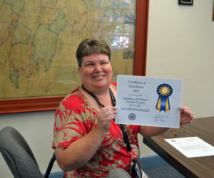 Lincoln County Register of Probate Catherine Moore holds a certificate of excellence the registry received from the U.S. Department of State National Passport Center. (Charlotte Boynton photo)