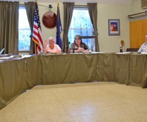 The Wiscasset Board of Selectmen votes to hold an open special town meeting to reconsider the planning department budget Tuesday, Aug. 1. From left: Selectmen Bob Blagden and Katharine Martin-Savage, recording secretary Jackie Lowell, Chair Judy Colby, Town Manager Marian Anderson, and Selectmen Ben Rines and Jeff Slack. (Abigail Adams photo)