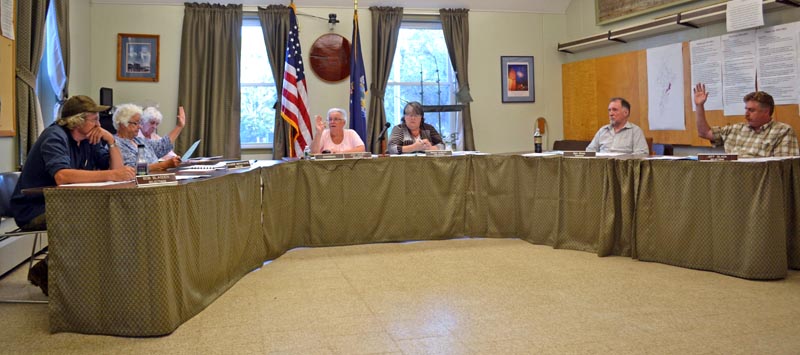 The Wiscasset Board of Selectmen votes to hold an open special town meeting to reconsider the planning department budget Tuesday, Aug. 1. From left: Selectmen Bob Blagden and Katharine Martin-Savage, recording secretary Jackie Lowell, Chair Judy Colby, Town Manager Marian Anderson, and Selectmen Ben Rines and Jeff Slack. (Abigail Adams photo)