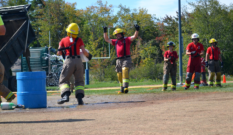 The Southport Fire Department knocks a lobster buoy out of the bucket during the mystery competition, part of the muster during the 54th annual Maine State Federation of Firefighters Convention. (Abigail Adams photo)