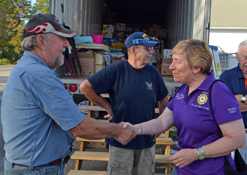 Robert Sewall, of The American Legion Wells-Hussey Post No. 42, shakes hands with Diane E. Duscheck, the national president of the American Legion Auxiliary. Duscheck visited Damariscota on Wednesday, Sept. 13 to learn more about the post's hurricane-relief efforts. (Maia Zewert photo)