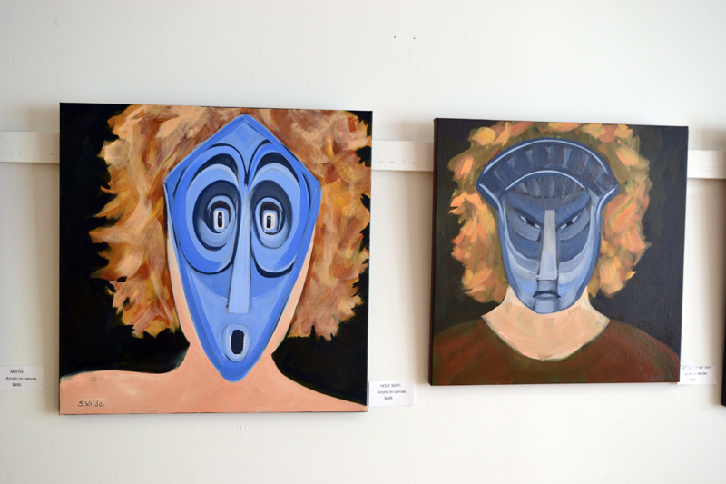 Two of the six paintings in Sarah Wilde's masks series in the West Gallery of River Arts. (Christine LaPado-Breglia photo)