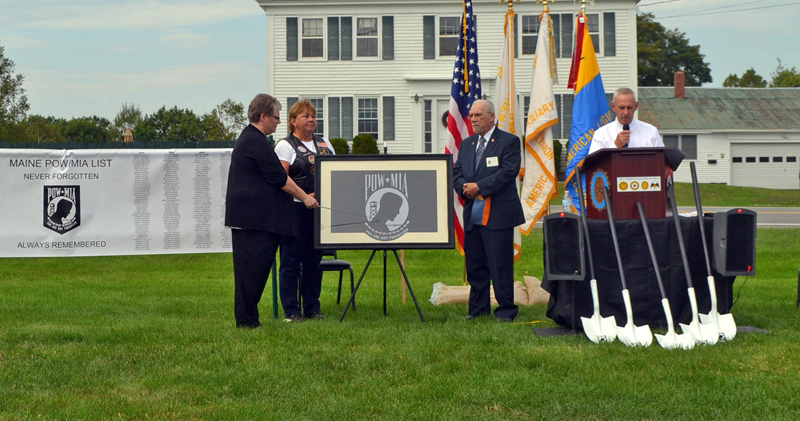 State American Legion Cmdr. Randall Kluj (right) explains the design of the POW/MIA flag during the groundbreaking ceremony for a POW/MIA memorial at the Legion's state headquarters in Winslow. From left: state American Legion Auxiliary President Ann Durost, American Legion Riders State Director Kaye Bouchard, and Sons of the American Legion National Executive Committeeman David Raymond. (Charlotte Boynton photo)