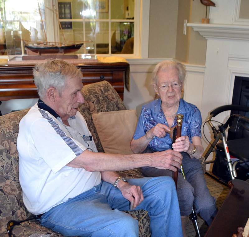 Westport Island First Selectman George Richardson Jr. presents the town's Boston Post Cane to Elizabeth "Betty" Pierce during her 100th birthday party at Chase Point Assisted Living in Damariscotta on Sept. 26. (Charlotte Boynton photo)