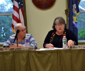 Wiscasset Town Manager Marian Anderson (right) reads a citizen's petition to transfer planning funds to surplus Tuesday, Sept. 12 as Wiscasset Board of Selectmen Chair Judy Colby looks on. (Abigail Adams photo)