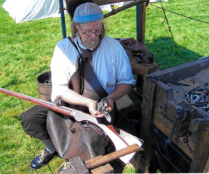 Jeffrey Miller works on a wheellock musket at Colonial Pemaquid State Historic Site.