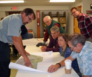 Crooker Construction's recently hired environmental coordinator, Michael Abbott (left), shows a map of proposed Bailey Road changes to attendees of an Oct. 3 informational meeting in Alna. (Christine LaPado-Breglia photo)