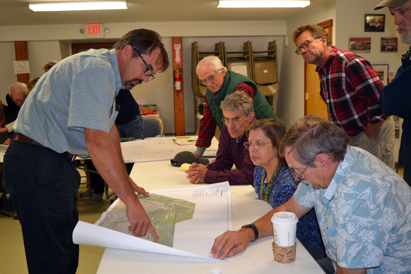 Crooker Construction's recently hired environmental coordinator, Michael Abbott (left), shows a map of proposed Bailey Road changes to attendees of an Oct. 3 informational meeting in Alna. (Christine LaPado-Breglia photo)