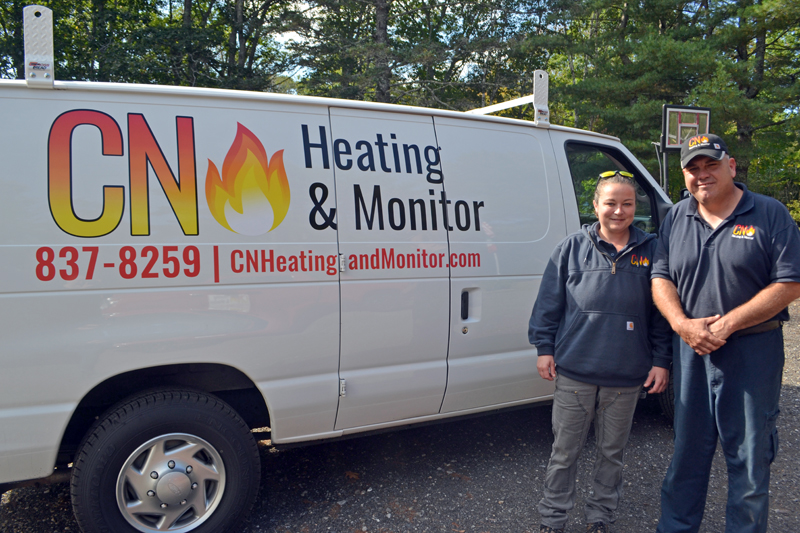 Caitlin Pinkerton and Nick Falabella, the partners behind CN Heating & Monitor, stand next to the company van at their headquarters in Round Pond. (Maia Zewert photo)