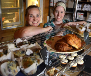 Longtime friends Crystal Berg (left) and Andrea "Annie" Leck stand behind a collection of Barn Door Baking Co. offerings Saturday, Oct. 14, the first of the business's open bakery days. (Maia Zewert photo)