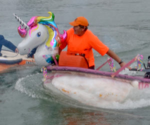 Buzz Pinkham (right) passes Tom Lishness during the Damariscotta Pumpkinfest Regatta on Monday, Oct. 9. (Maia Zewert photo)