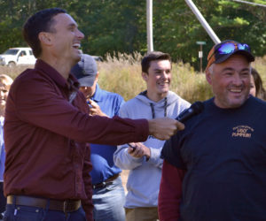 Charlie Lopresti (left) laughs as Scott St. Laurent reacts to the weighing of his pumpkin Sunday, Oct. 1. St. Laurent grew a 1,330-pound fruit, his first fruit over 1,000 pounds. (Maia Zewert photo)