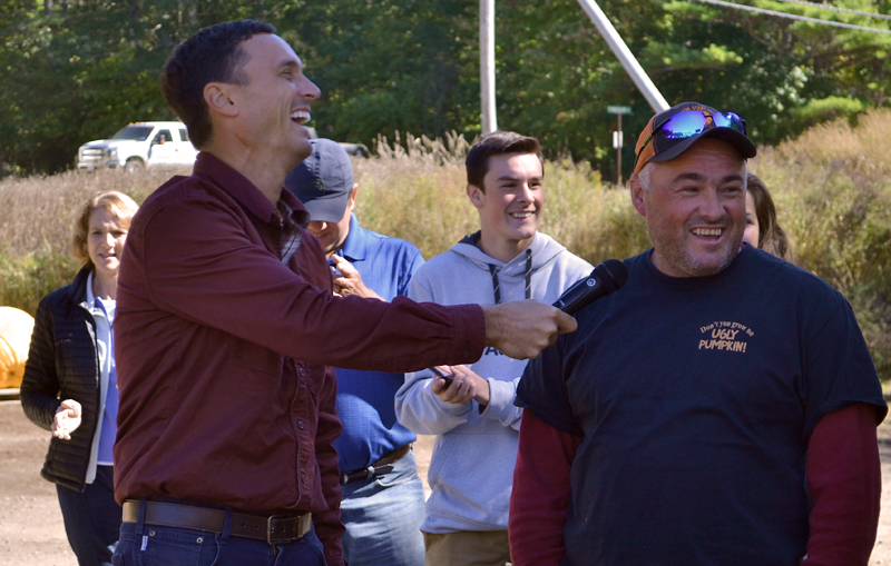 Charlie Lopresti (left) laughs as Scott St. Laurent reacts to the weighing of his pumpkin Sunday, Oct. 1. St. Laurent grew a 1,330-pound fruit, his first fruit over 1,000 pounds. (Maia Zewert photo)