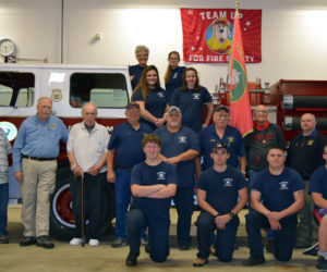 Edgecomb Fire Department members past and present pose for a photo at the fire station Thursday, Oct. 5. Front row from left: Aidan Tracey, Josh Kramley, Marc Babineau, and Ryan Potter. Middle: former Chief Barry Johnston, former Assistant Chief Larry Omland, Capt. Steve Fenton, Bill Witzell, Lt. Roland Abbott, Lt. Daren Graves, Capt. Tom Trowbridge, Assistant Chief John Potter, and Chief Roy Potter. Bottom row on truck: Ryann Trask and Leah Potter. Top row: Chaplain Kate Pinkham and Amanda Babineau. (J.W. Oliver photo)