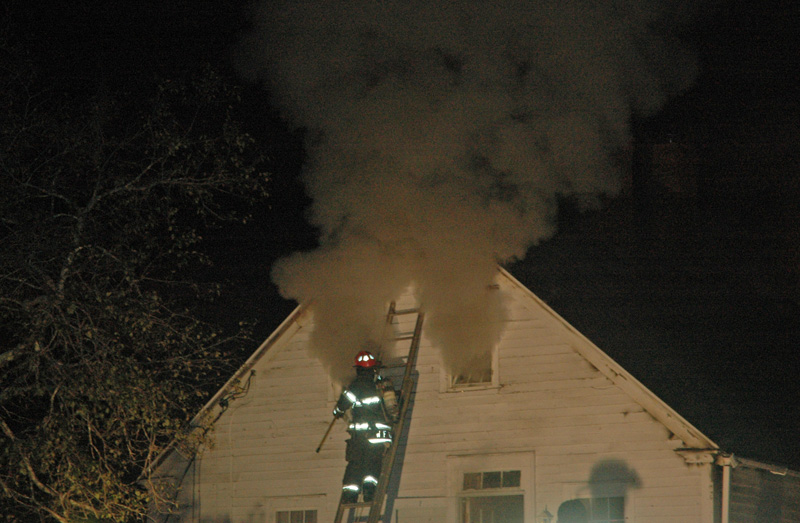 Smoke billows from the windows of a house at 44 Indian Trail in Newcastle on Friday, Oct. 20. (Alexander Violo photo)