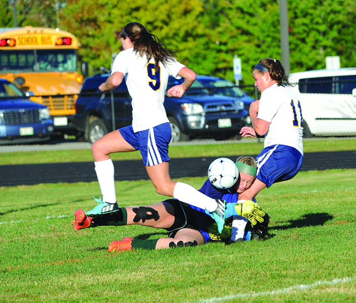 Abby Nelson and Hallie Kunesh pressure Leavitt keeper Shelby Varney. (Paula Roberts photo)