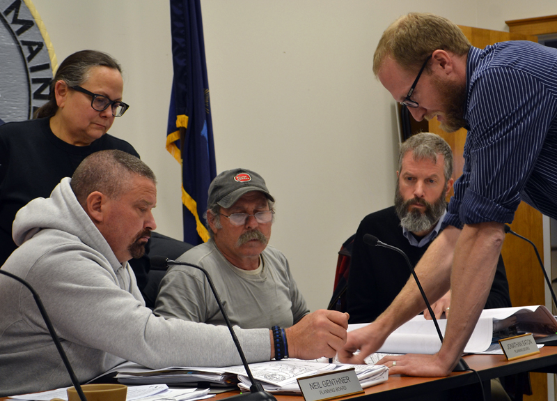 From left: Damariscotta Planning Board members Shari Sage, Neil Genthner, Jonathan Eaton, and Adam Maltese look on as engineer Shawn Tobey explains part of the plan for the 435 Main St. development Monday, Nov. 13. (Maia Zewert photo)