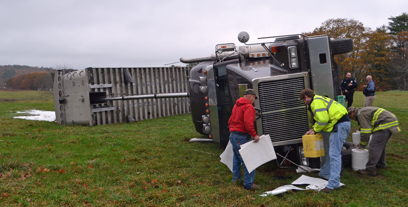 Damariscotta firefighters clean up oil spilled when a tractor-trailer tipped over at the Damariscotta River Association's Great Salt Bay Farm and Heritage Center the morning of Monday, Nov. 6. (Maia Zewert photo)