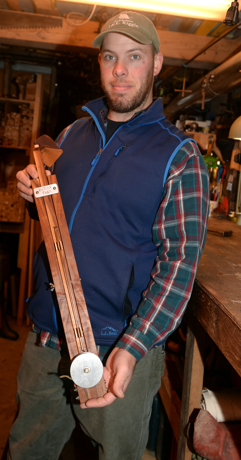 Oliver Butler holds an ice fishing trap made with apple wood. Butler makes traps from many kinds of wood at Butler Traps in Damariscotta Mills. (Paula Roberts photo)