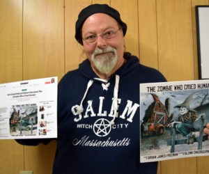 Newcastle artist Glenn Chadbourne holds a print-out of an Entertainment Weekly post about his forthcoming book (left) and an advance copy of the book, "The Zombie Who Cried Human."