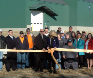 Lee and Jennifer Richards prepare to cut the ribbon for ProKnee's new manufacturing facility and warehouse as ProKnee employees look on Monday, Nov. 20. (Alexander Violo photo)