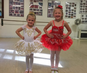 Michaela Harrington (left) and Hayley Frame try on their costumes for the upcoming production of "Land of Sweets."